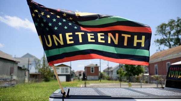 A Juneteenth flag flies on a float during the 45th annual Juneteenth Natio<em></em>nal Independence Day celebrations in Galveston, Texas, on June 15, 2024. Juneteenth falls on June 19 and has often been celebrated on the third Saturday in June, to mark the end of slavery in the US. (Photo by Mark Felix / AFP) (Photo by MARK FELIX/AFP via Getty Images)
