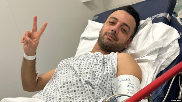 FILE - Pouria Zeraati, a presenter for independent Persian-language outlet Iran International, flashes a victory sign in a photo he posted of himself on X March 30, 2024, while hospitalized after a stabbing attack.