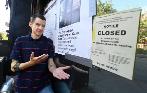 Tobly micsith pointing to the closed signs on the front of his cfe