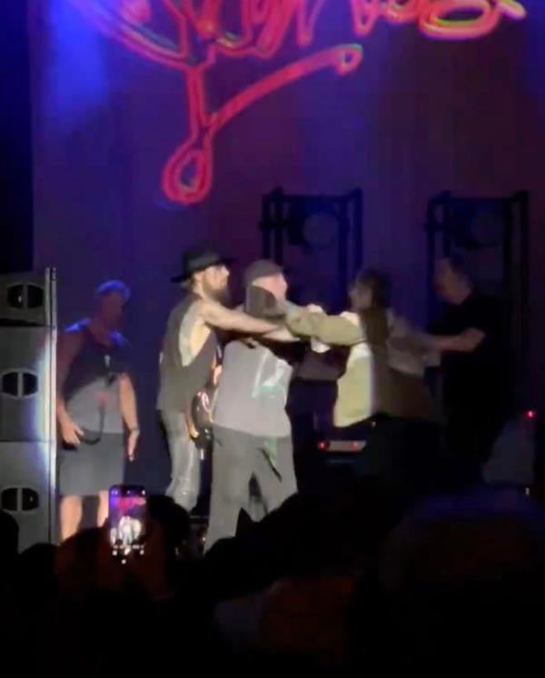 Several crew members and bassist Eric Avery, ran up and restrained the hotheaded singer.